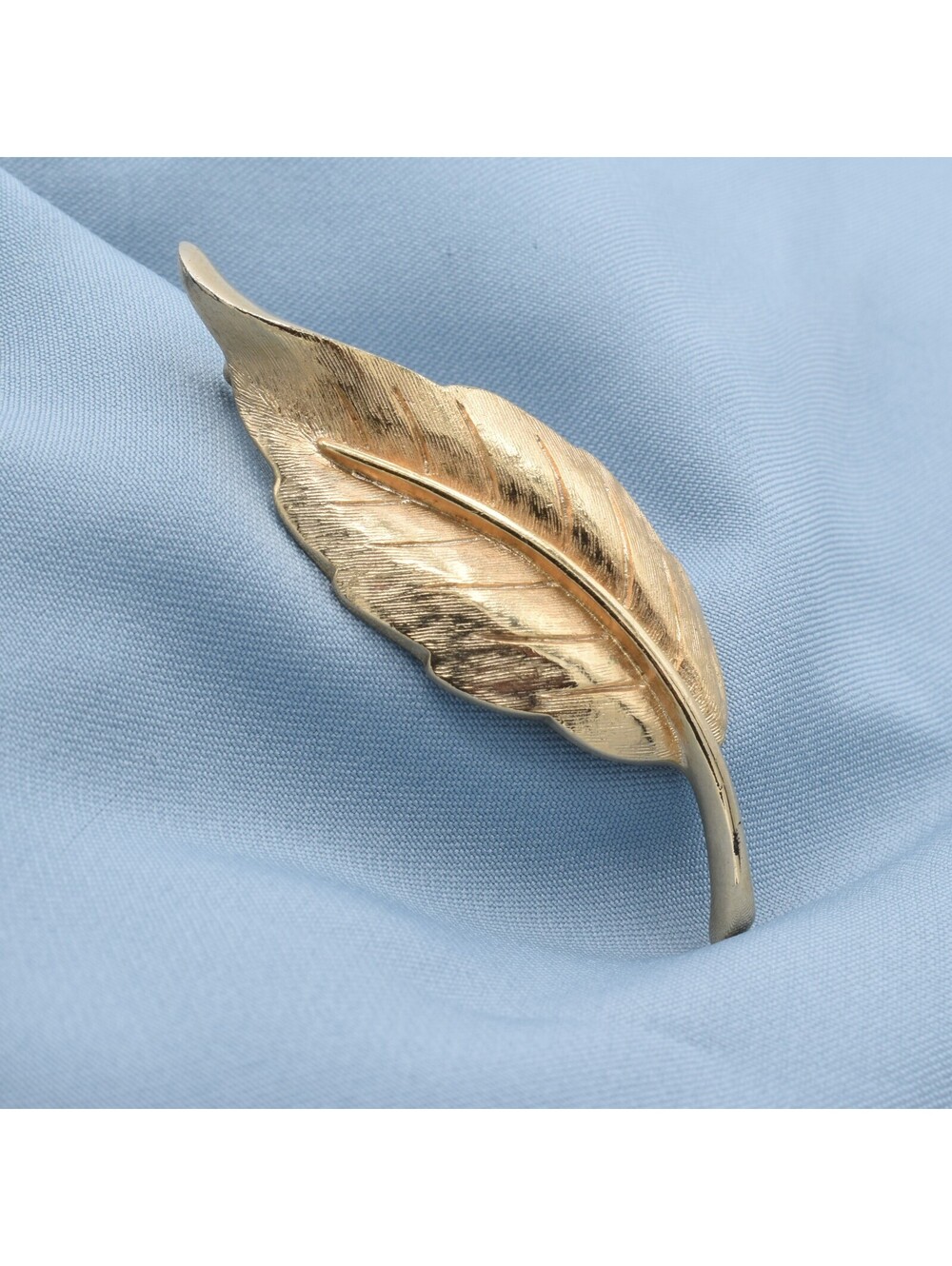 This is a vintage Avon gold-toned leaf brooch.